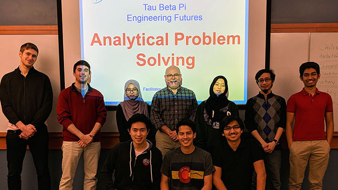 Engineering Future Leaders facilitator posing with group of students.
