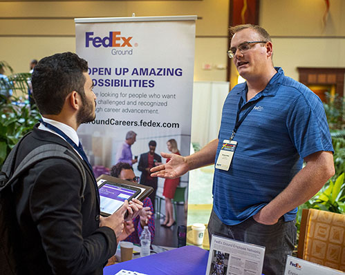 Recruiter speaking to student during the recruiting fair.